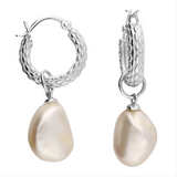 Silver hoop earrings with pearl drops on a white background