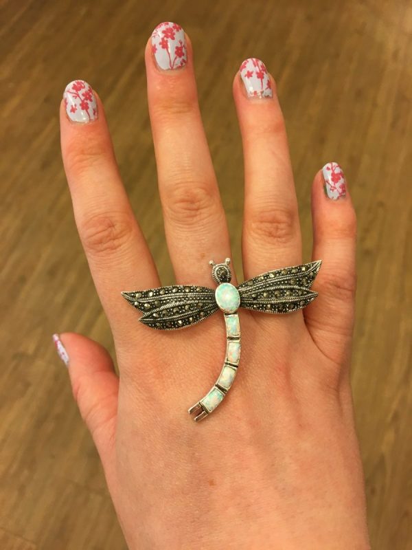 A Marcasite and Opalite dragonfly brooch shown on LJ’s hand