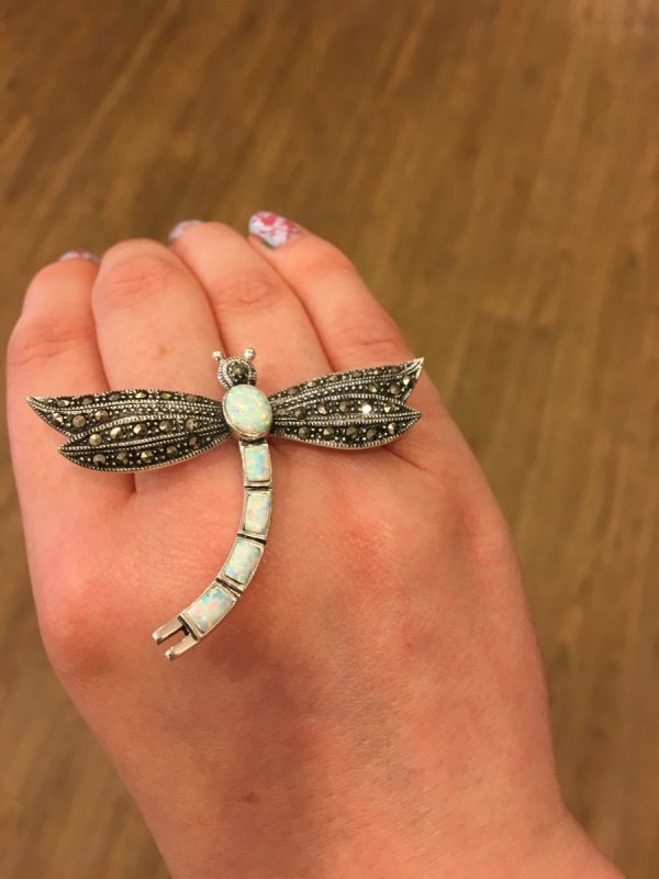 A Marcasite and Opalite Dragonfly Brooch shown on LJ’s hand.