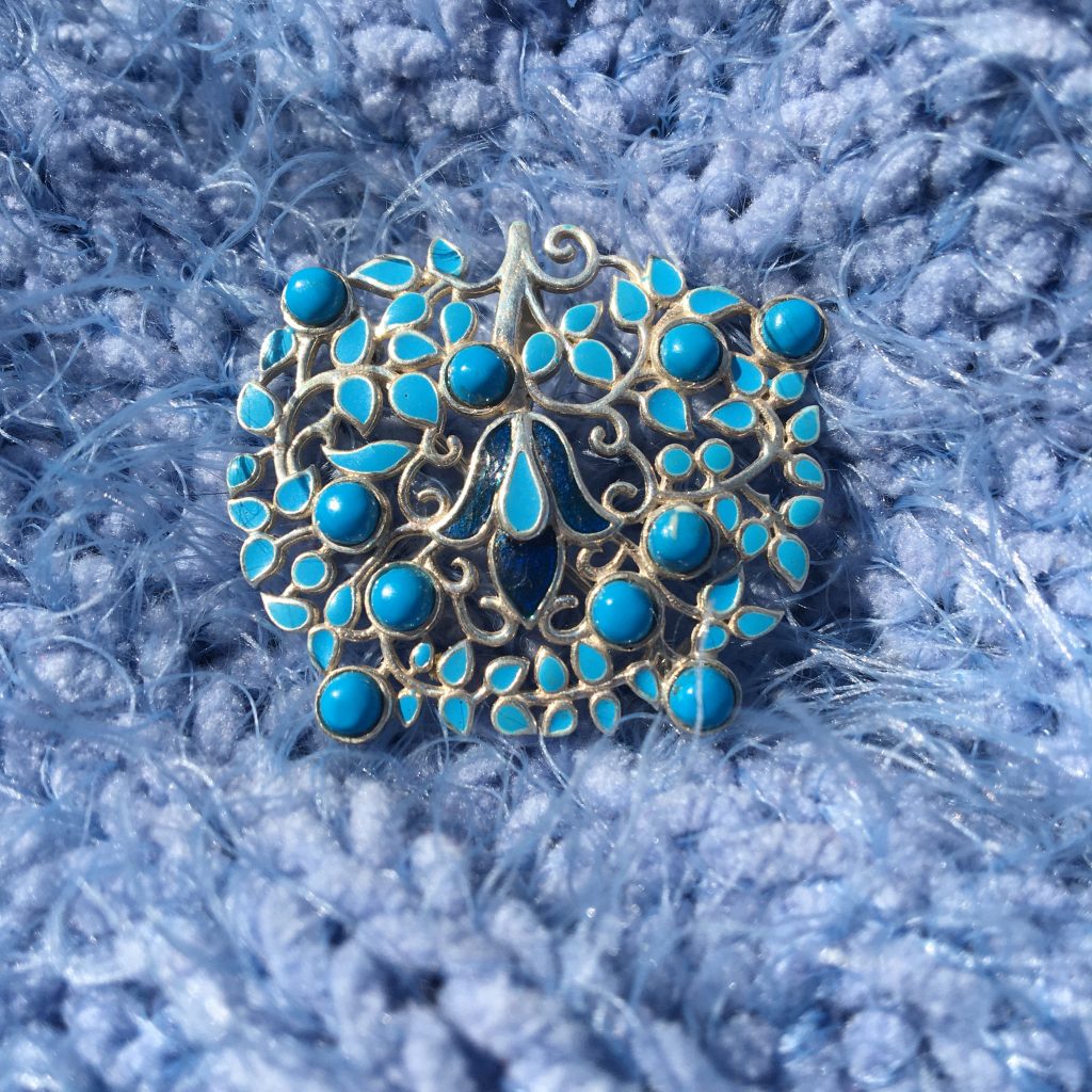 Turquoise and Enamel Brooch on soft blue